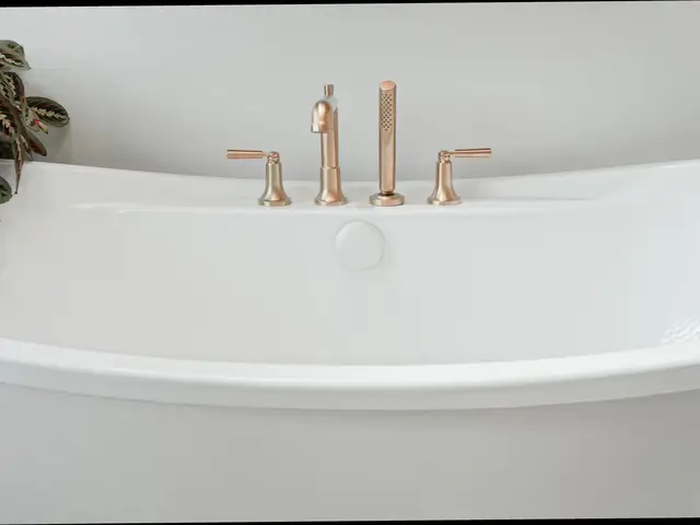 Front view of the white bathtub with gold-tone deck-mounted faucet and handles.