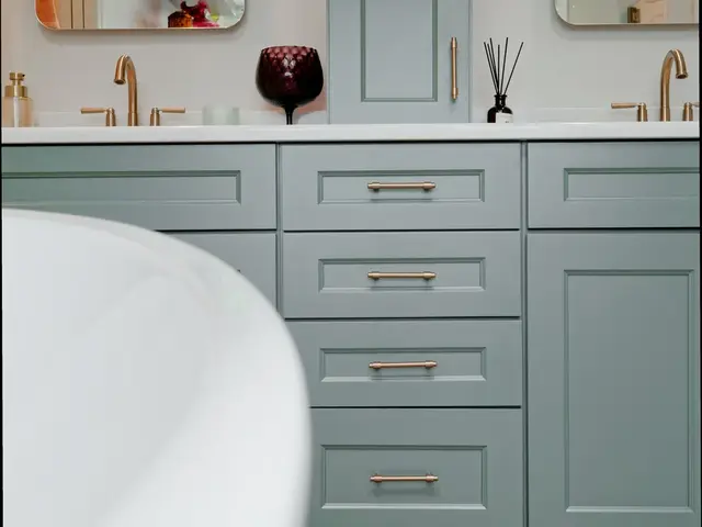 Vertical view of the blue-green double vanity with gold-tone handles and two mirrors.