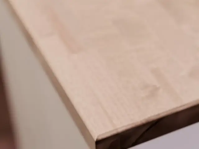 Close-up of the wood island countertop showing its surface and squared edge.